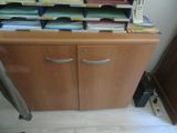 a file cabinet with many files on top of it