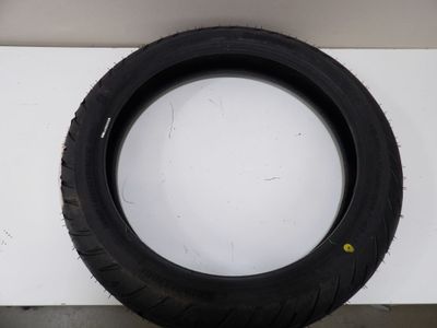 a tire on a white surface with a black rim