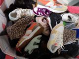 many pairs of shoes in a basket on the floor