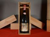 a bottle of wine in a wooden box on a table
