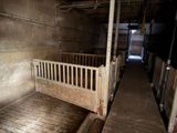 a bed in the middle of a room with a wooden floor