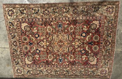 a large antique persian rug with a red and blue design