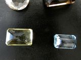 four different colored stones are arranged on a black surface