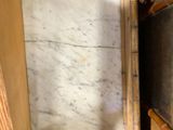 a small mirror in the corner of a wooden cabinet