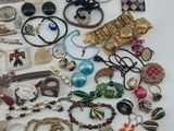 a pile of assorted jewelry sitting on a table
