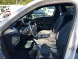 the interior of a car with the door open and the passenger seat down