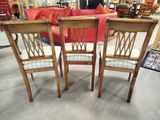 two wooden chairs with upholstered seats in a store