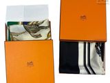 an orange box with a tie and a pair of socks in it
