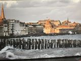 a picture of a picture of a city by the water