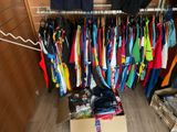 a lot of shirts hanging on a clothes rack