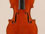 an old violin with a bow hanging from it ' s back