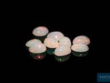 some white oplites are sitting on a black surface