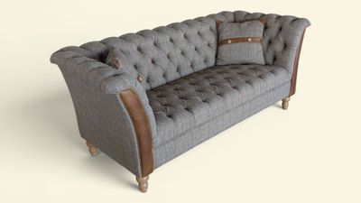 a gray couch with a brown leather arm rest