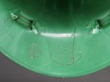a close up of a green hat with a logo on it