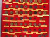 a red display case filled with lots of old coins