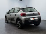 the rear of a silver citrole car parked in a garage