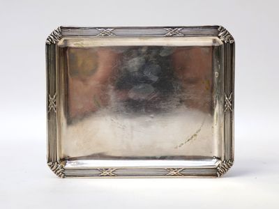 a silver plate with a picture of a dog on it