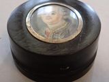 a small black box with a picture of a woman on it