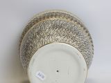 a close up of a vase with a tag on it