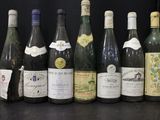 several bottles of wine are lined up in a row on a table