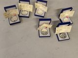 several silver coins are in a blue box on a table