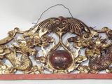 a gold and red wall decoration with animals on it