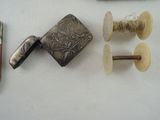 a silver lighter and a pair of scissors on a table