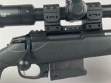 a close up of a rifle with a scope on a white background