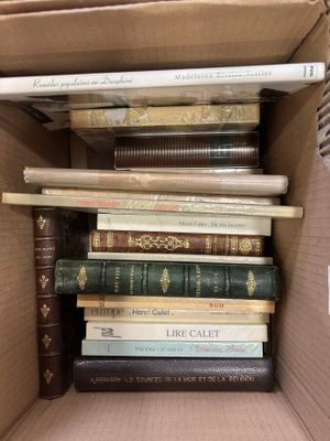 a box full of books that are stacked on top of each other
