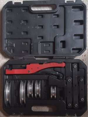 a black case with a red handle and a wrenet in it