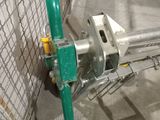 a metal gate with a green handle in a building