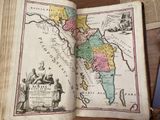 an old book with a map on it sitting on a table