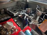 many pots and pans on the counter in the kitchen