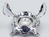 a silver plate with spoons and spoons in it