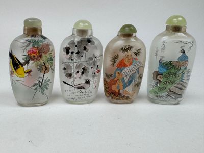 four glass snuff bottles with birds and flowers on them