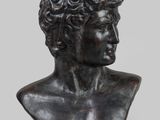 a bronze bust of a young man with curly hair