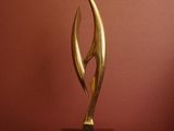 sculpture on a pedestal in front of a red wall