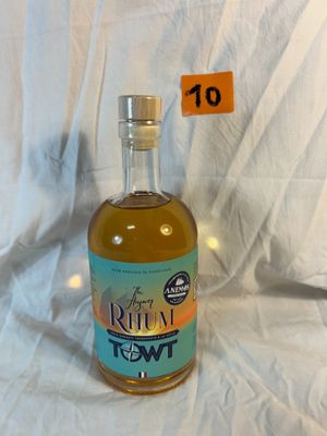 a bottle of liquor sitting on a white cloth