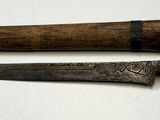 two knives that are sitting on a white surface