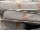 three pairs of shoes in a plastic bag on the ground