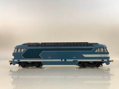 a blue and white train on a white surface