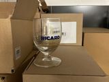a glass of wine sitting on top of a cardboard box