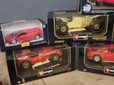 four red and yellow toy cars in boxes on a wooden floor