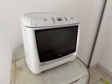 a white microwave sitting on top of a white cabinet