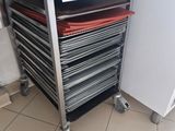 a metal cart with a lot of trays on it