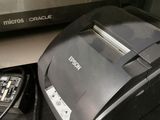 a receipt machine sitting next to a printer on a counter