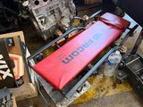 a picture of a car engine and parts in a garage