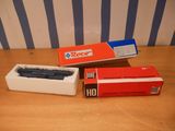 two boxes of razors sitting on a table next to a box of razors