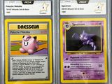 two pokemon trading cards are on display in a case