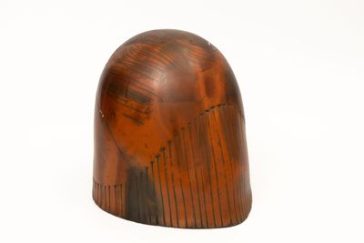 a wooden object that is sitting on a white surface